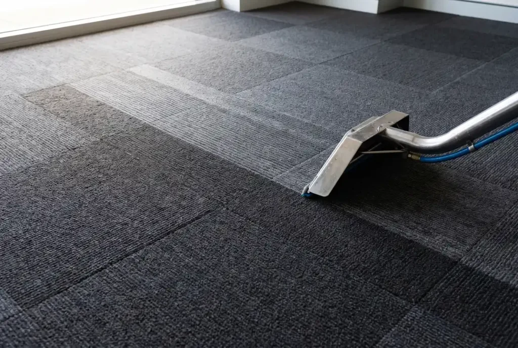 Freshly cleaned commercial office carpet tiles in Mandurah with extraction wand and crisp vacuum lines