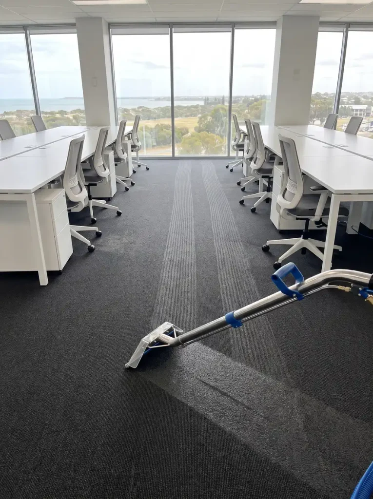 Freshly cleaned commercial office carpet with vacuum lines and cleaning wand in Mandurah